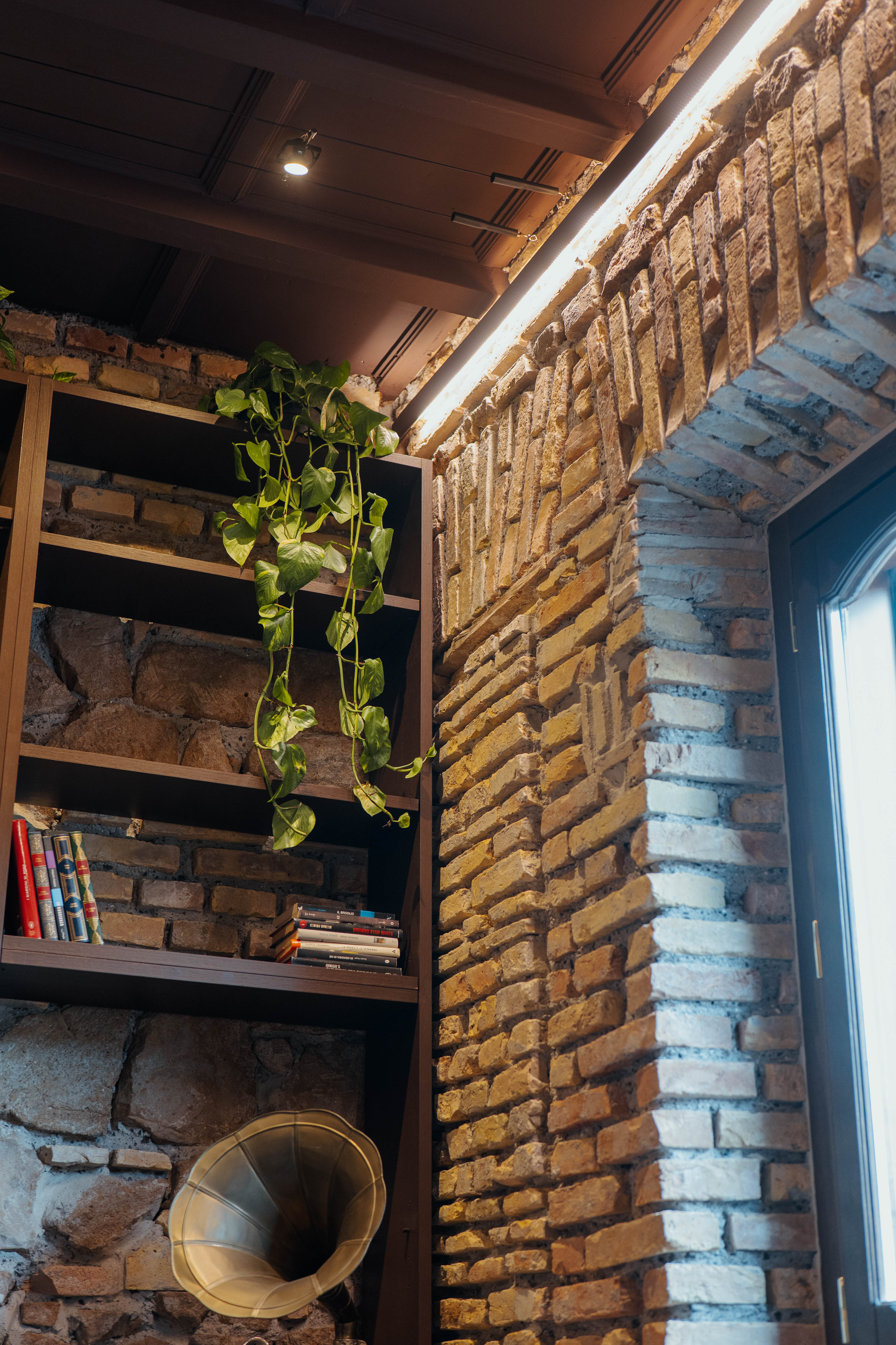 Libreria a parete con mattoni a vista, Salotto Industrial — ristrutturazione salotto a Roma · HOME360
